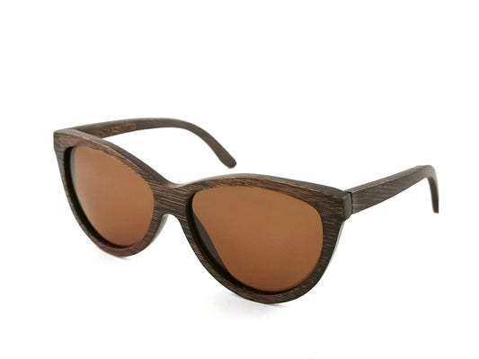 Diagonal view of brown bamboo sunglasses with amber lenses.