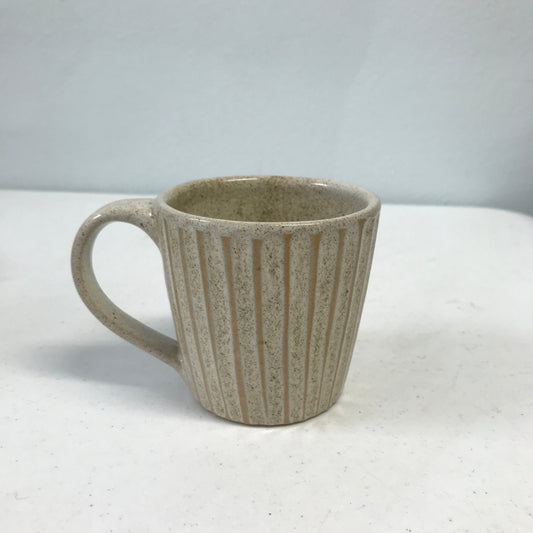 Speckled mug with handle.