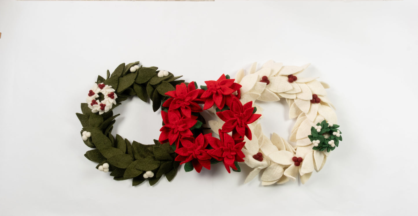 Felt ornaments of mini wreaths in green, red, and white.