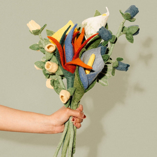 Blue, white, and yellow felt Calla Lilies in a bunch with other tropical flowers.