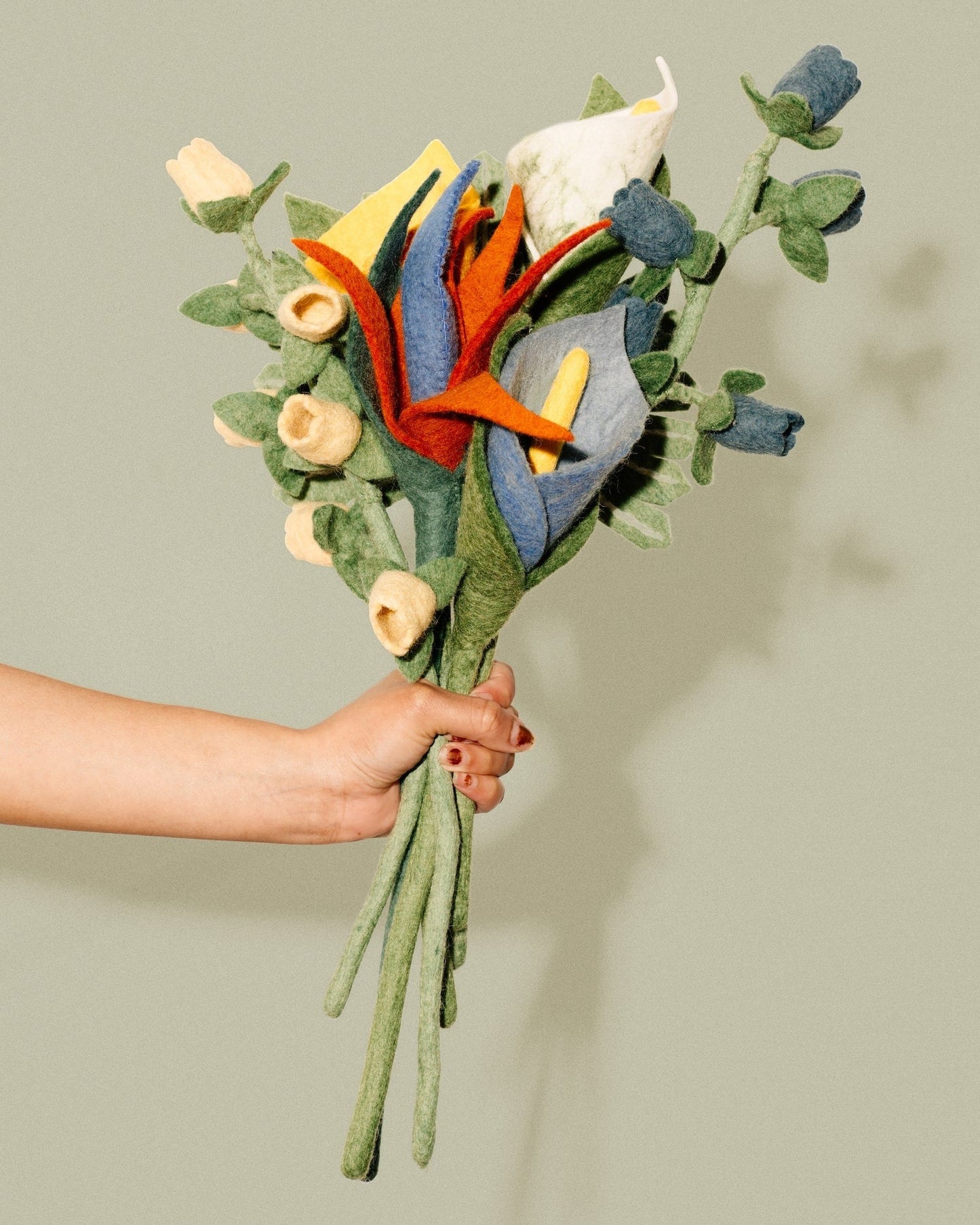 Blue, white, and yellow felt Calla Lilies in a bunch with other tropical flowers.