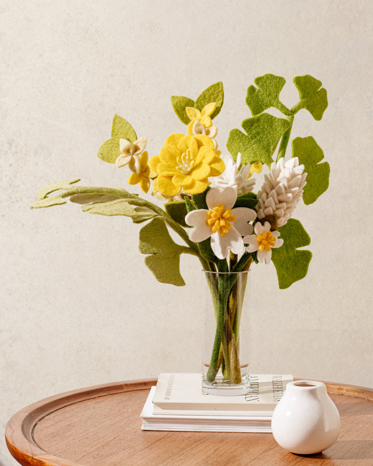 Pink, white, and light grey felt Dogwood flowers in clear vase.