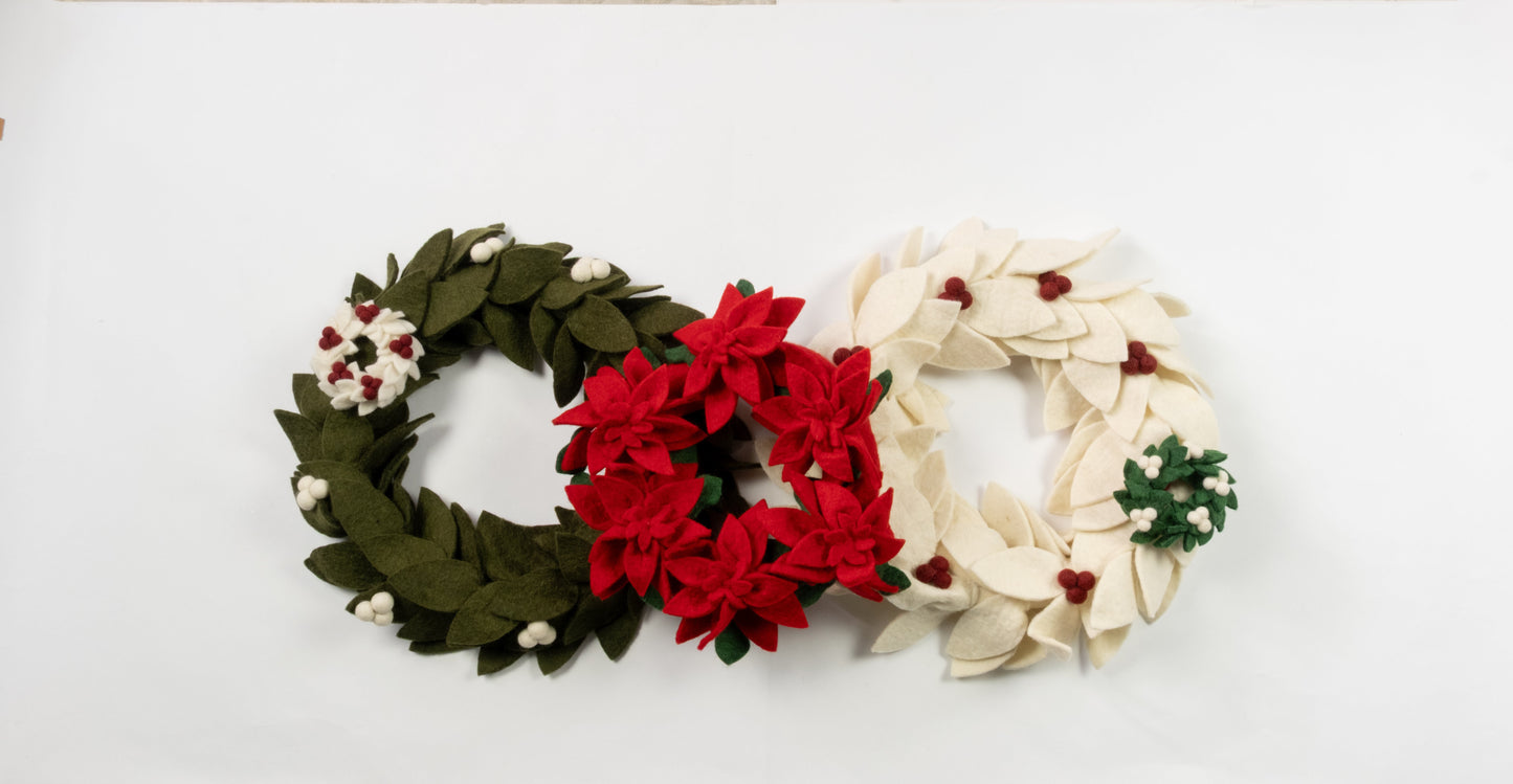 Felt ornaments of mini wreaths in green, red, and white.