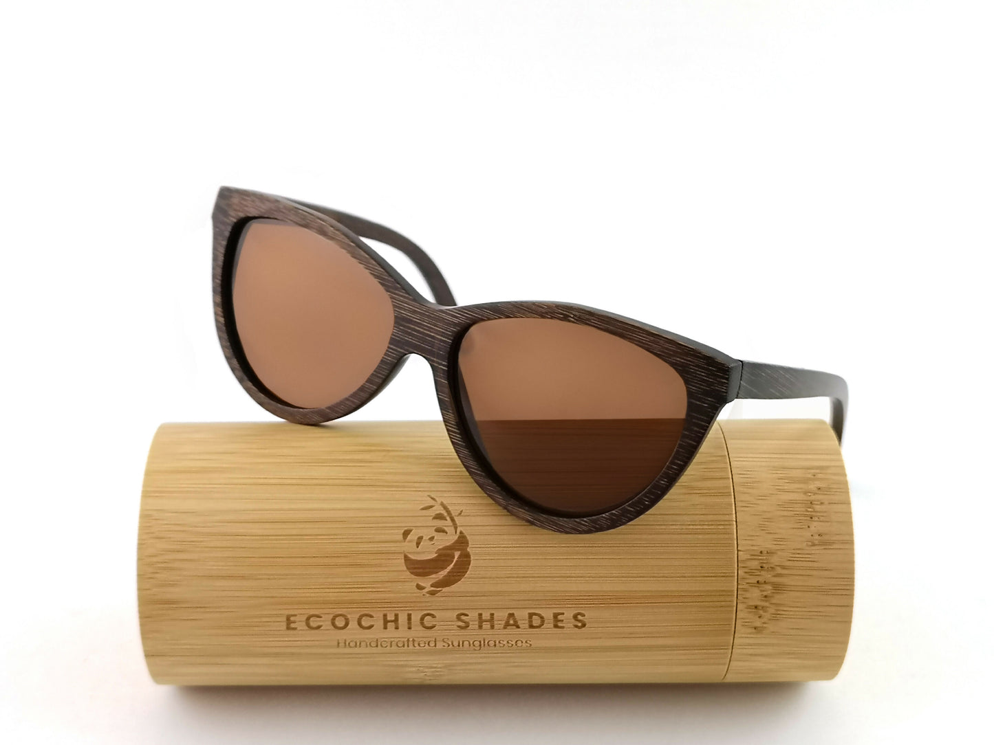 Brown bamboo sunglasses with amber lenses on cylindrical bamboo case.