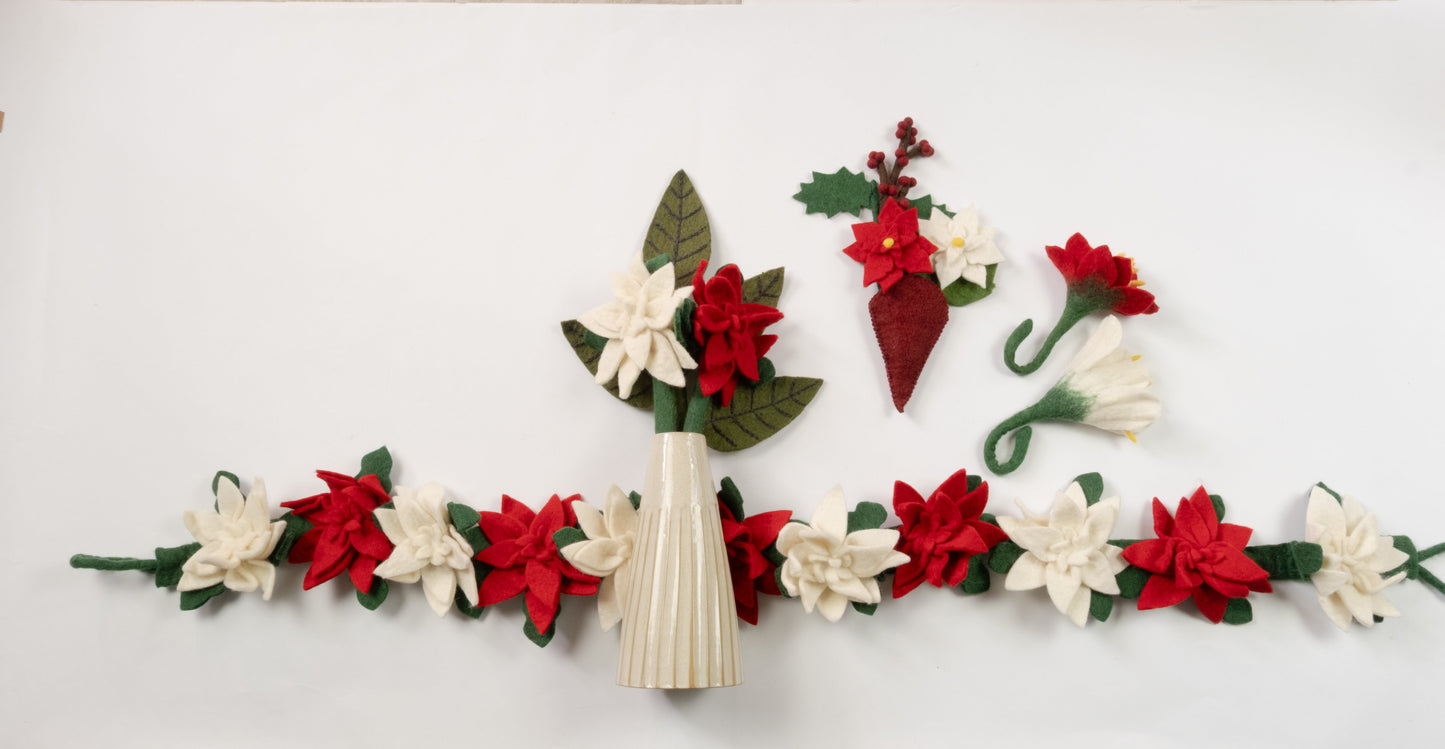 Felt ornaments of a red flower and a white flower with a red and white garland.