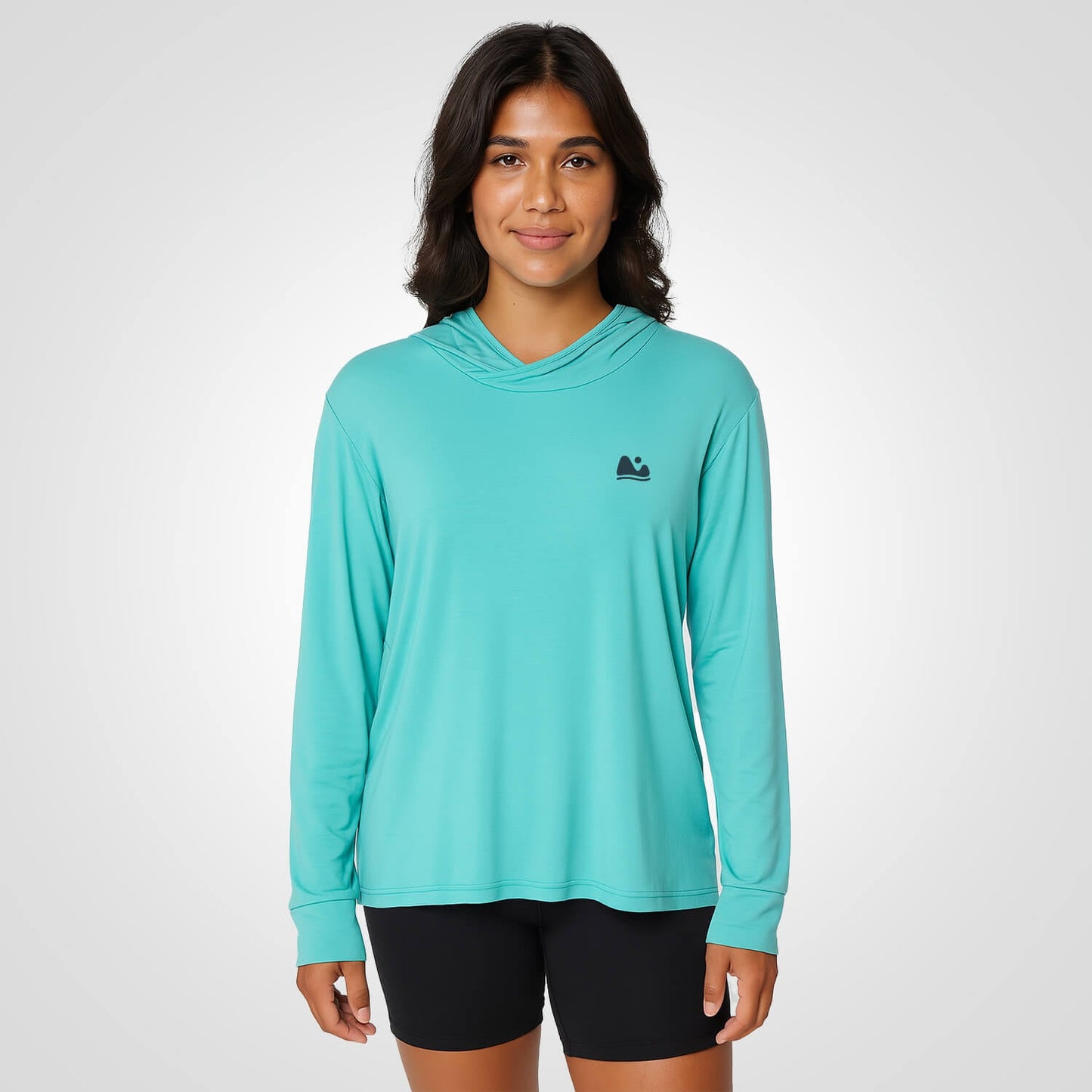 Woman wearing aqua bamboo sun shirt UPF ONE shirt and base layer.