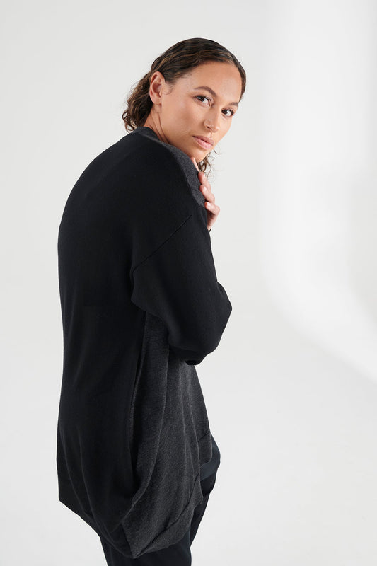 Side view of woman wearing charcoal/black cardigan.
