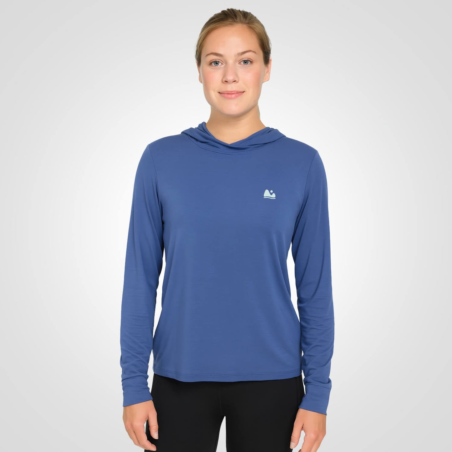 Woman wearing blue bamboo sun shirt UPF ONE shirt and base layer.