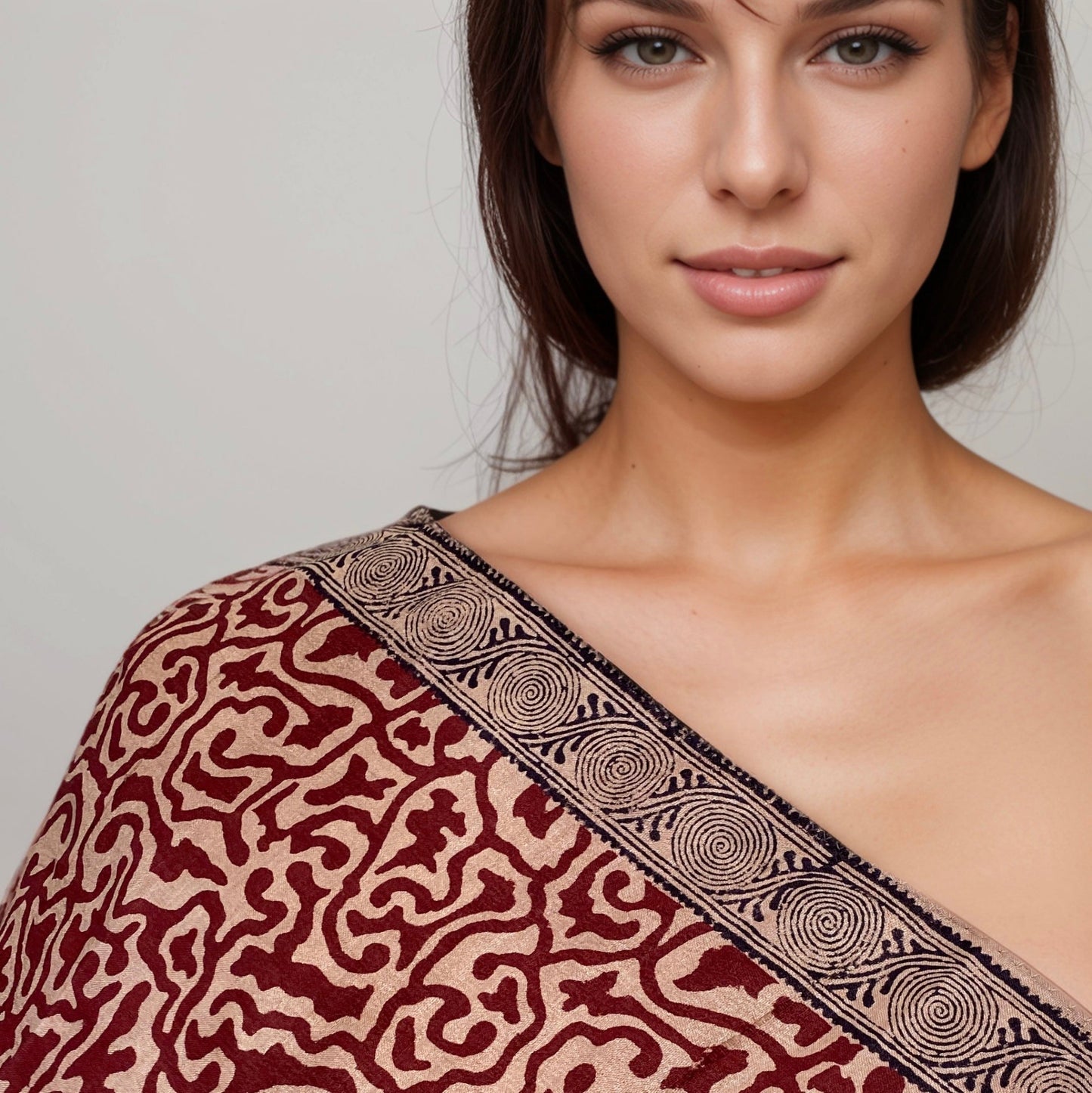 Front view closeup of woman with red, natural, black stole draped over right shoulder.