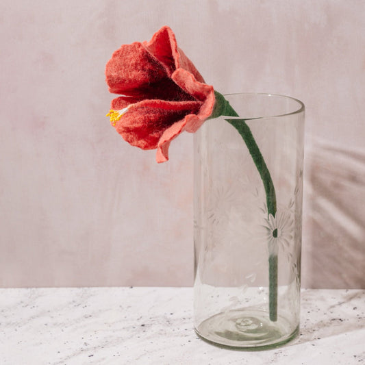 Etched clear glass vase with red flower.