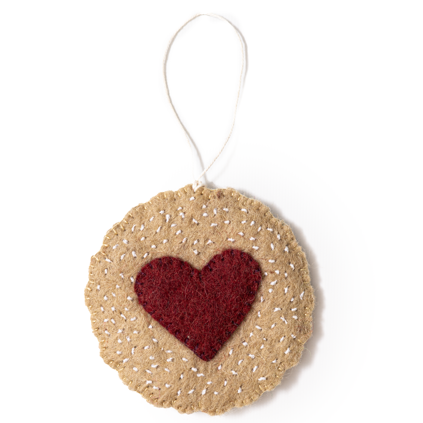 Felt ornament of a Linzer cookie with a red heart in the middle.