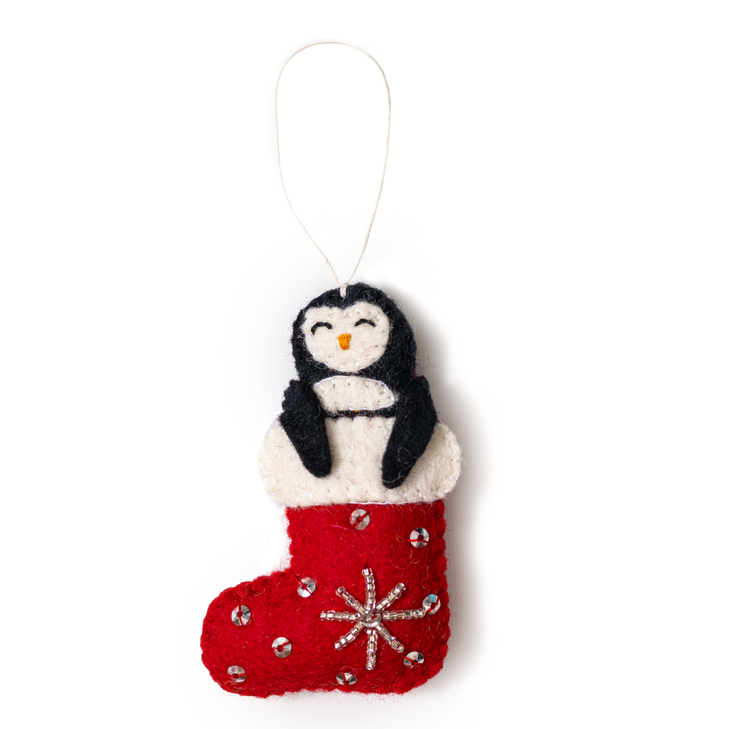 Felt ornament of a penguin sticking out of a red and white Christmas stocking.