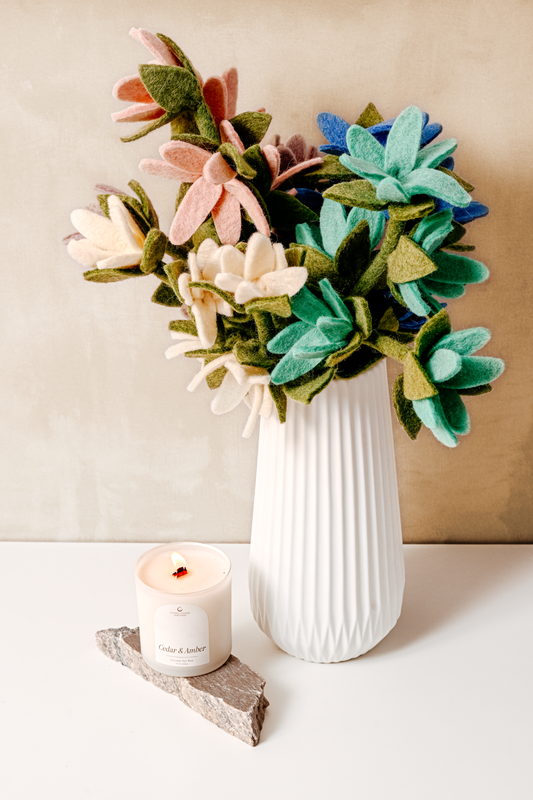 Pink, white, and light blue felt watsonia flowers in a white vase.