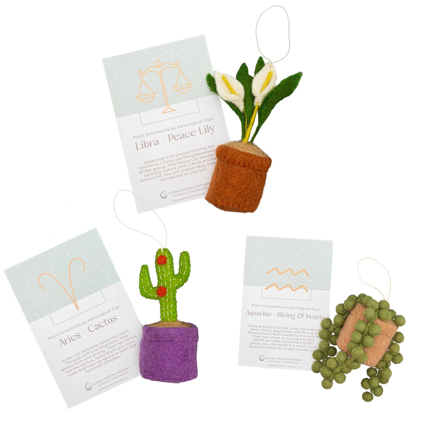 Felt zodiac ornaments of a cactus with Aries astrology card, a peace lily with Libra card, and a String of Pearls plant with an Aquarius card.