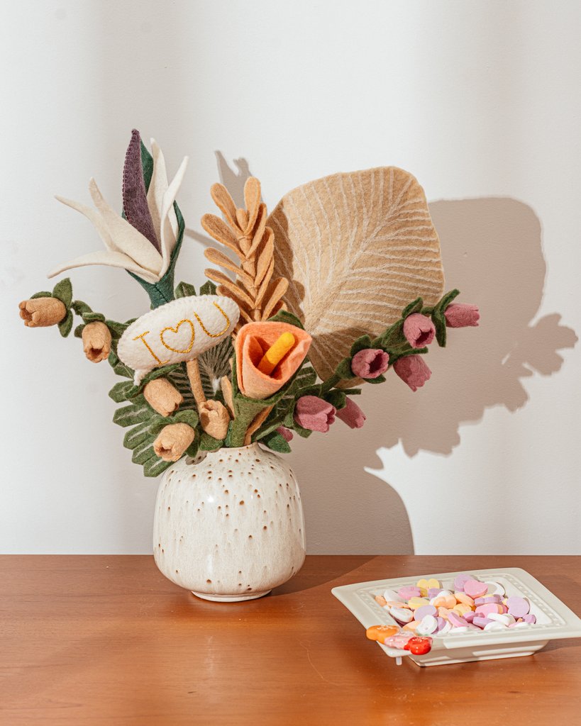 Pink and blush color felt Bellflowers in white vase with other felt flowers.