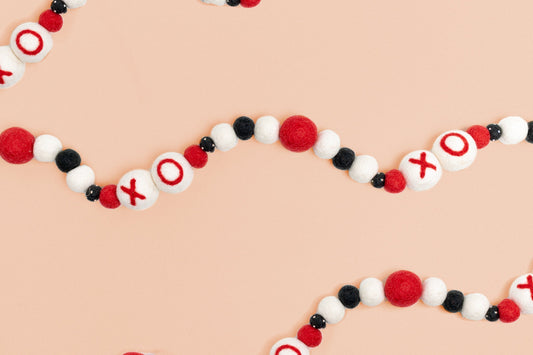 Felt garland with XO and red, white and black balls in between.