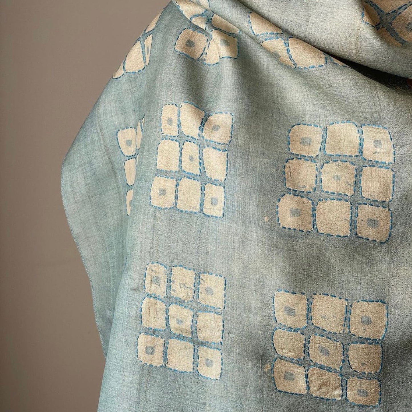 Closeup of Graduated ombre silk scarf with geometric design.