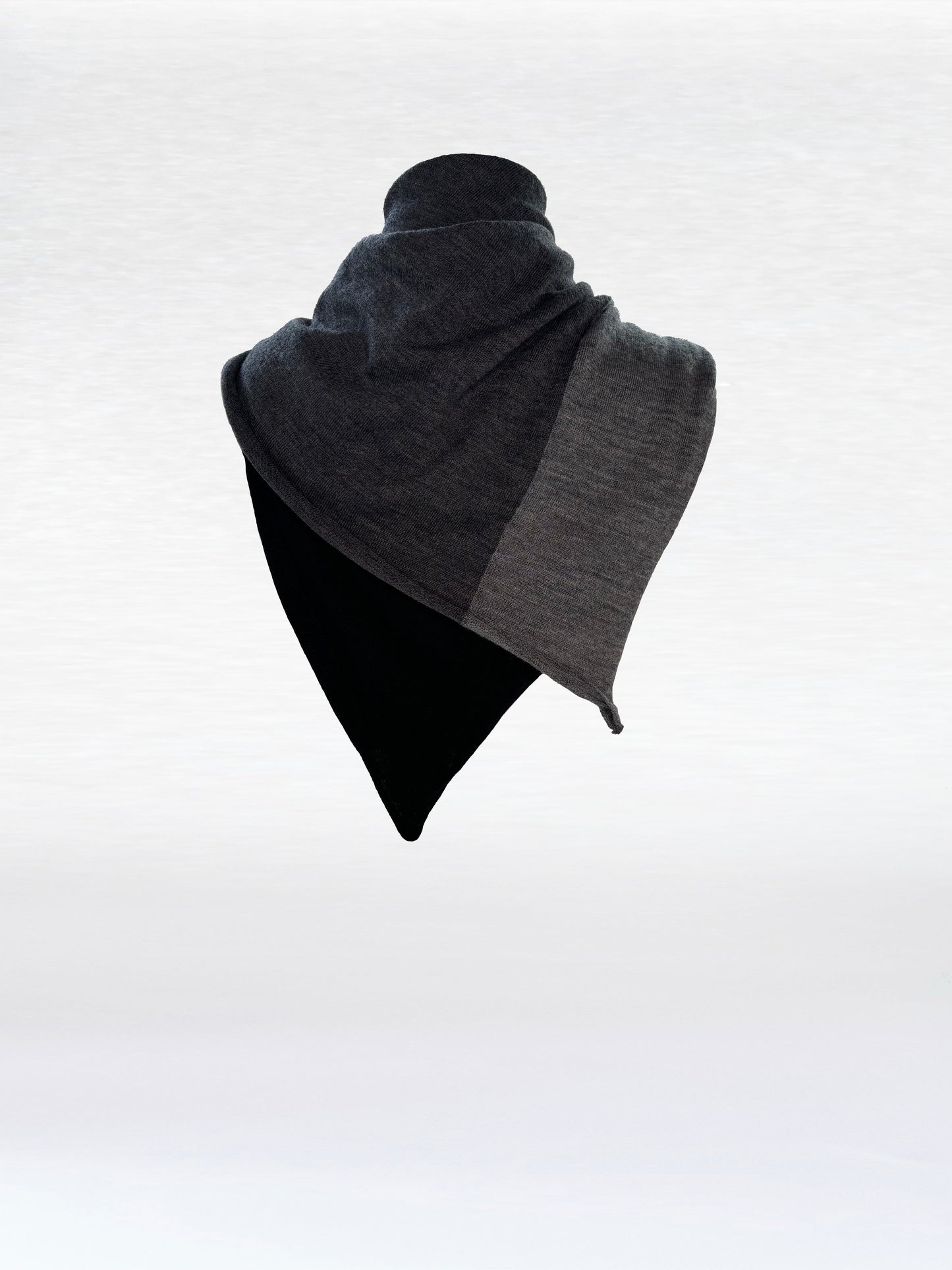 Scarf in black, charcoal, and light grey shaped as if wrapped around a mannikin.