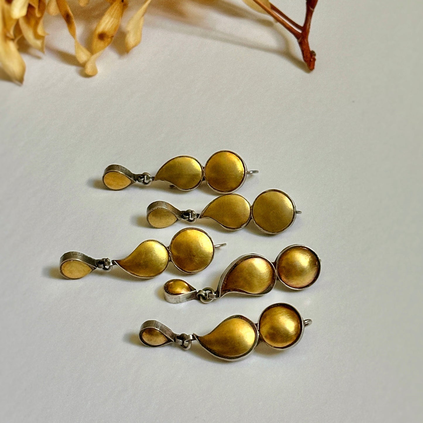 Grouping of 4 gold foil earrings with tribal design.