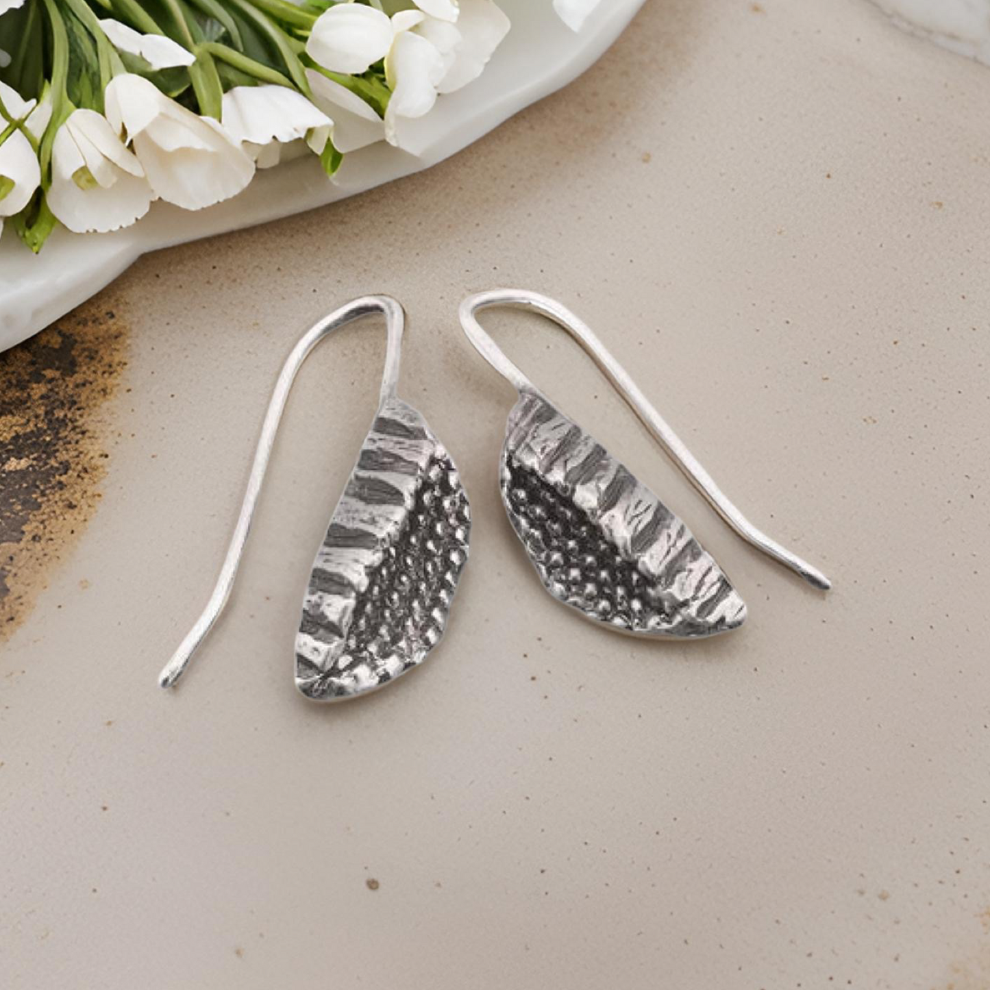 Silver beeja Pod earrings.