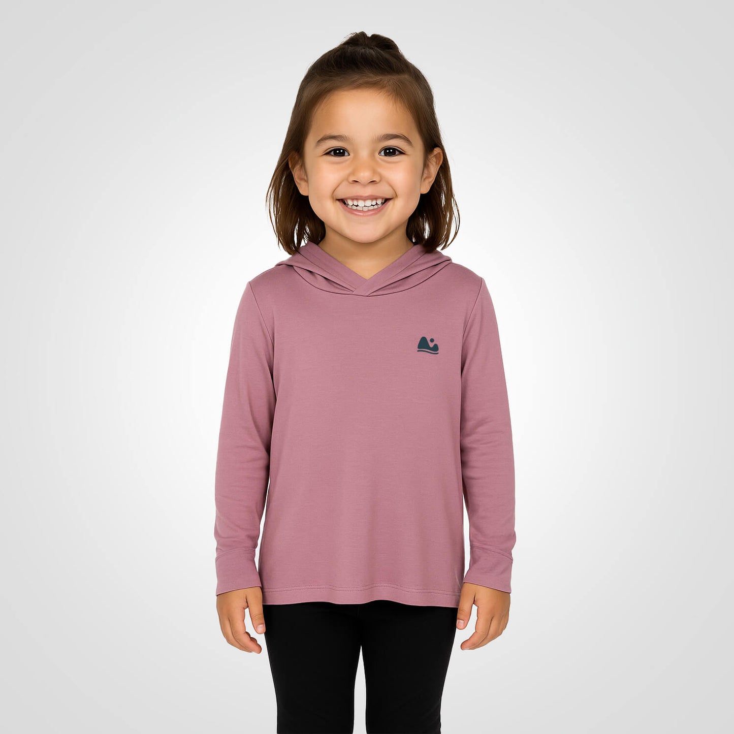 Girl wearing the sun protecting pink bamboo sun shirt and base layer.