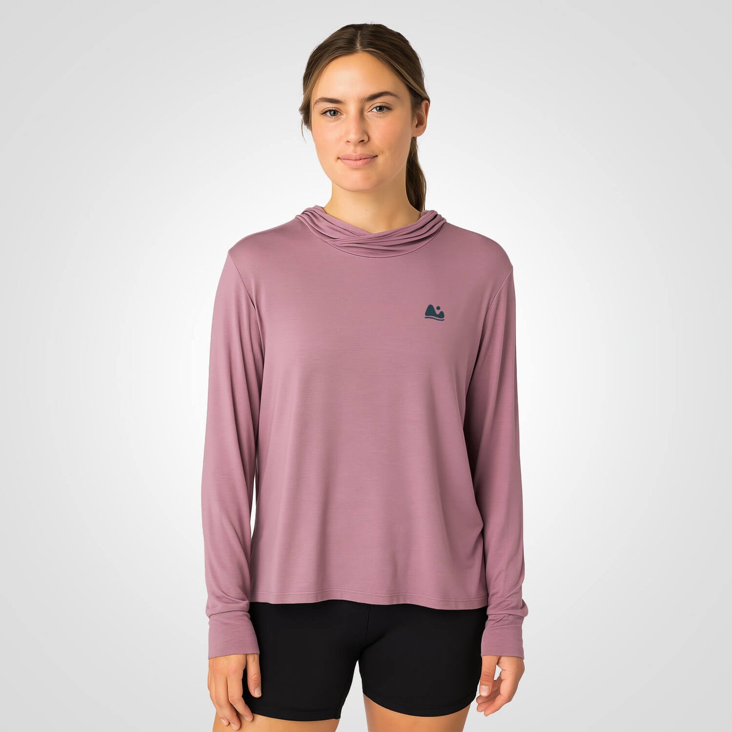 Woman wearing pink bamboo sun shirt UPF ONE shirt and base layer.