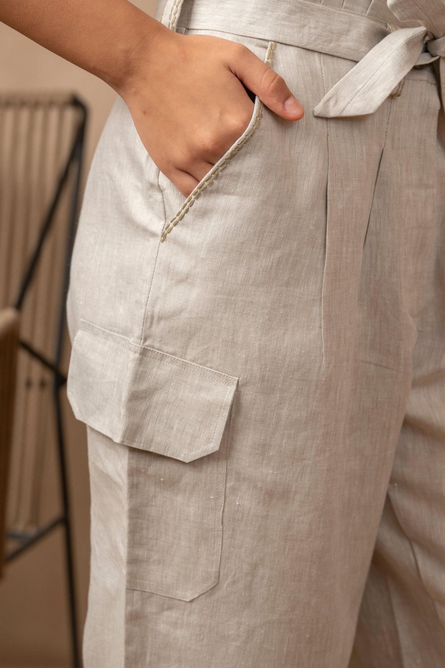Front right closeup view of woman with her right hand in the pocket of natural colored Yama Cargo Jogger Pants.