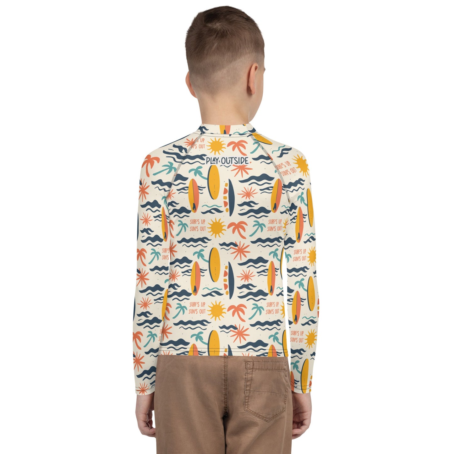 A youth rash guard featuring vibrant surf designs, made with eco-friendly, quick-drying fabric for versatile use.