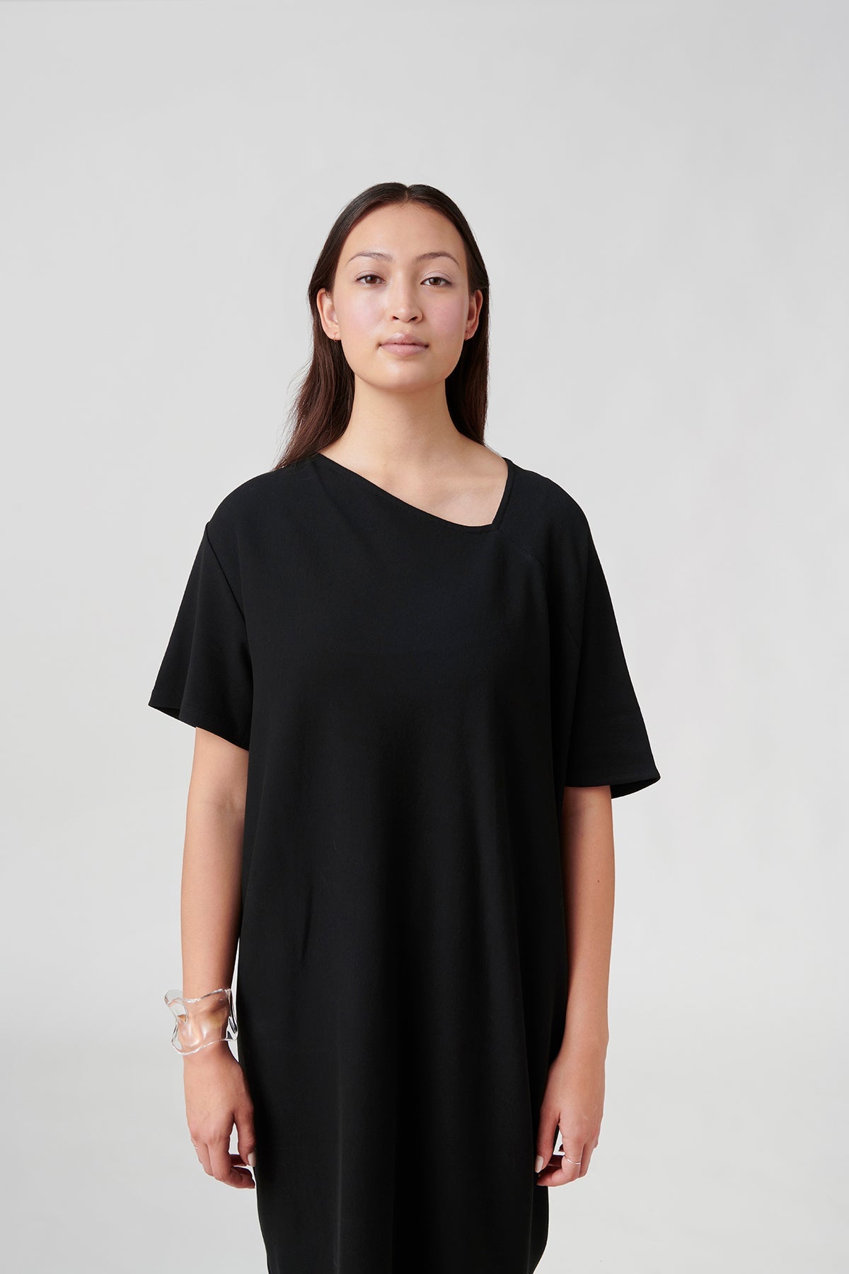 Front view of woman wearing black dress.
