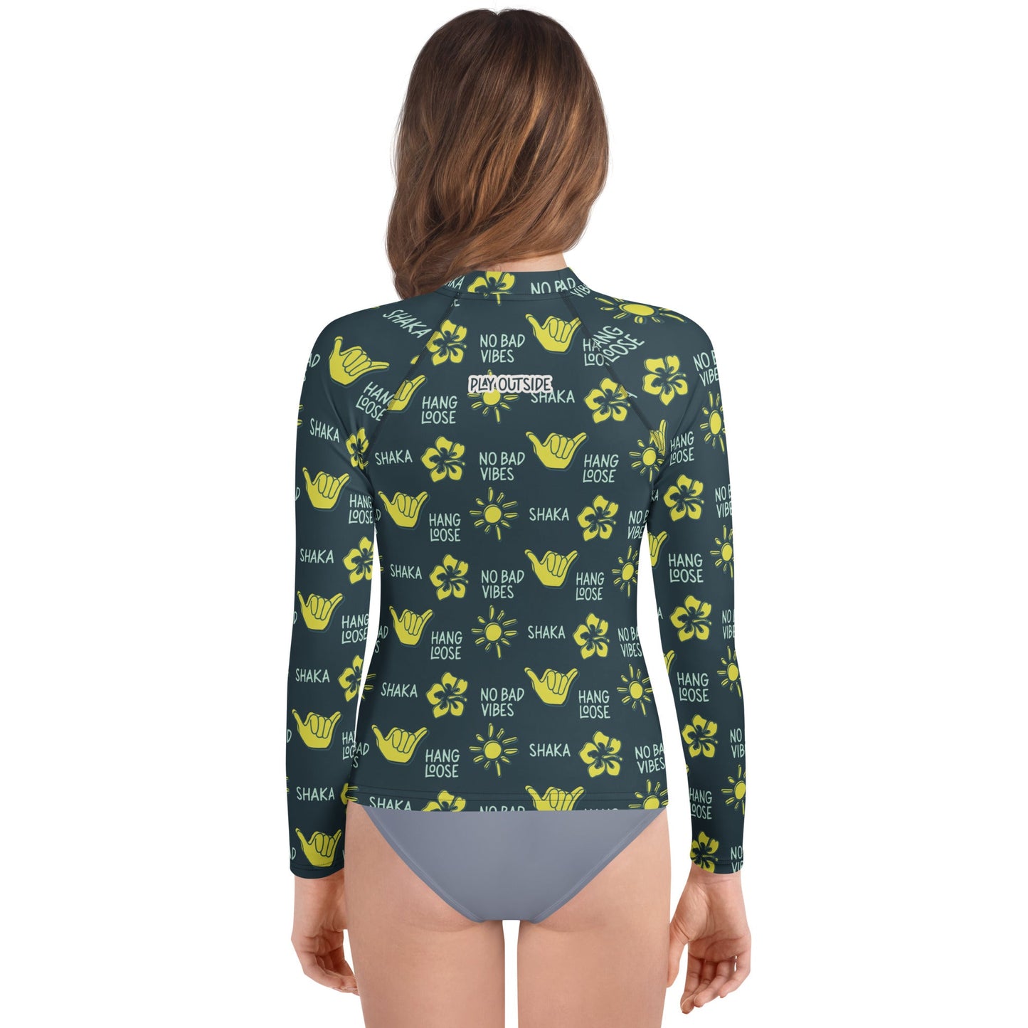 Back view of girl in dark blue rash guard with yellow designs of the sun, hibiscus flowers, hang loose hand sign, and the words hang loose, no bad vibes, and shaka.