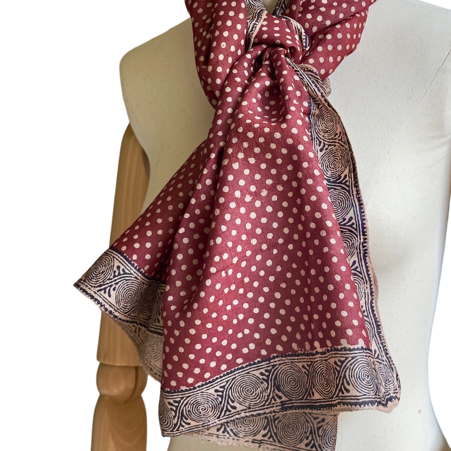 Manikin with red, natural, black stole. Natural polka dots on red background.