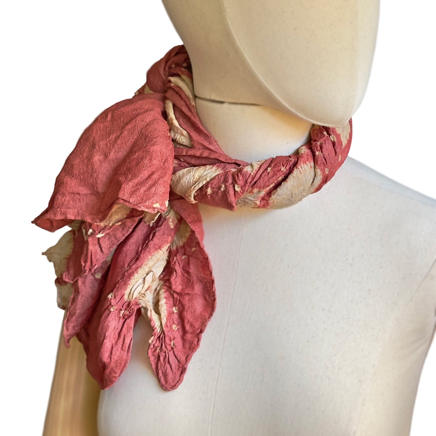 Mankikin model wearing tie dye scarf twisted and tied to the right.