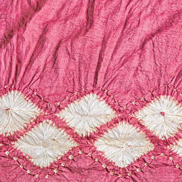 Closeup of tie dyed pink and white silk scarf.