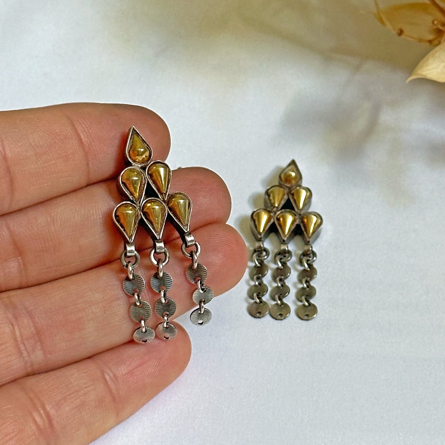 Pair of gold foil post earrings with tribal design.