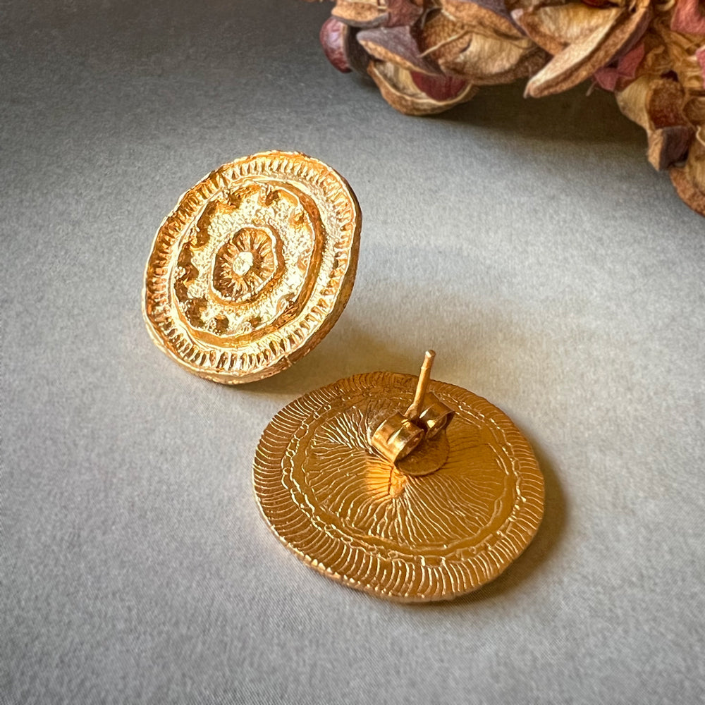 Front and back of pair of gold mandala earrings.