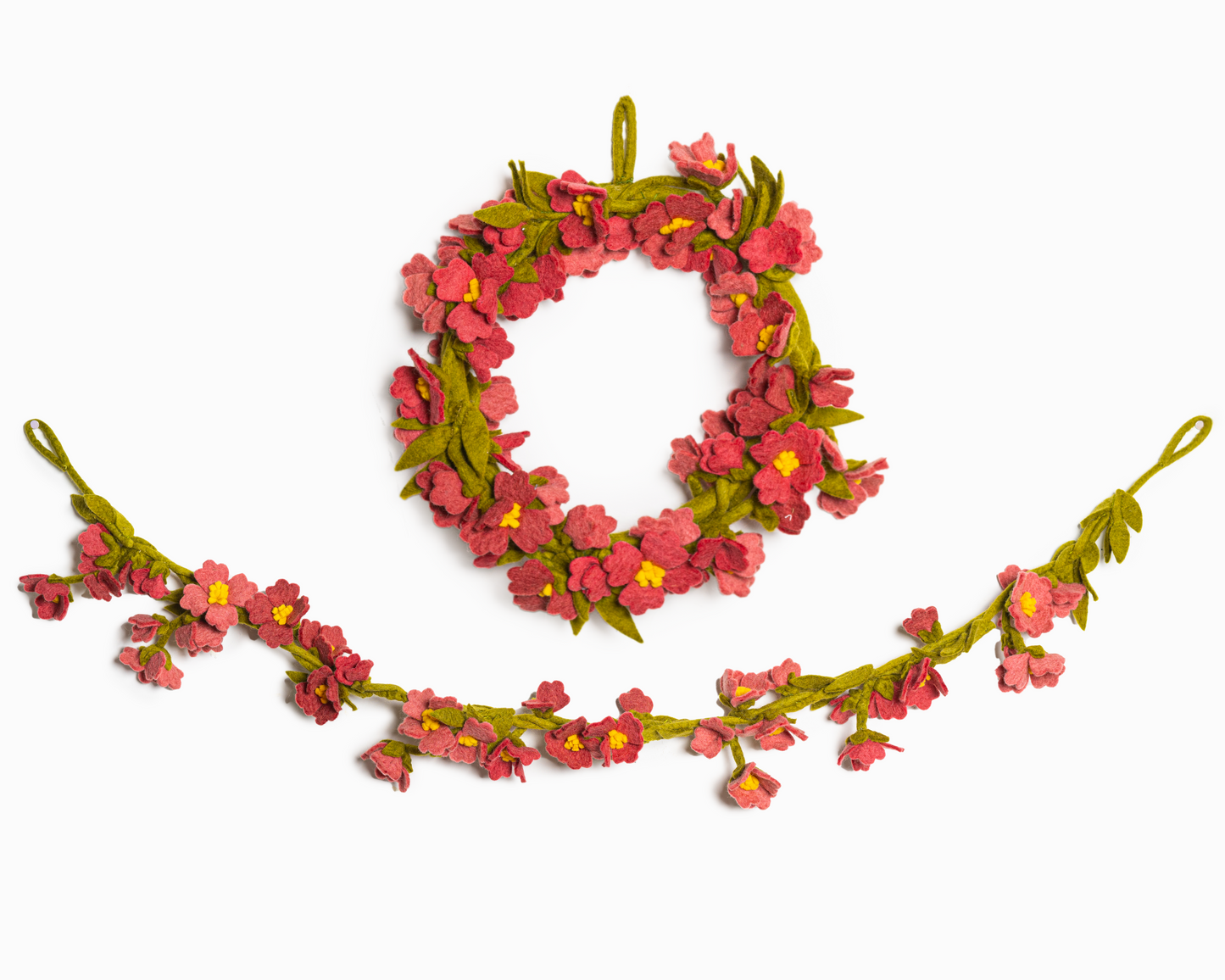 Felt garland of pink cherry blossoms and green leaves hanging below matching wreath.