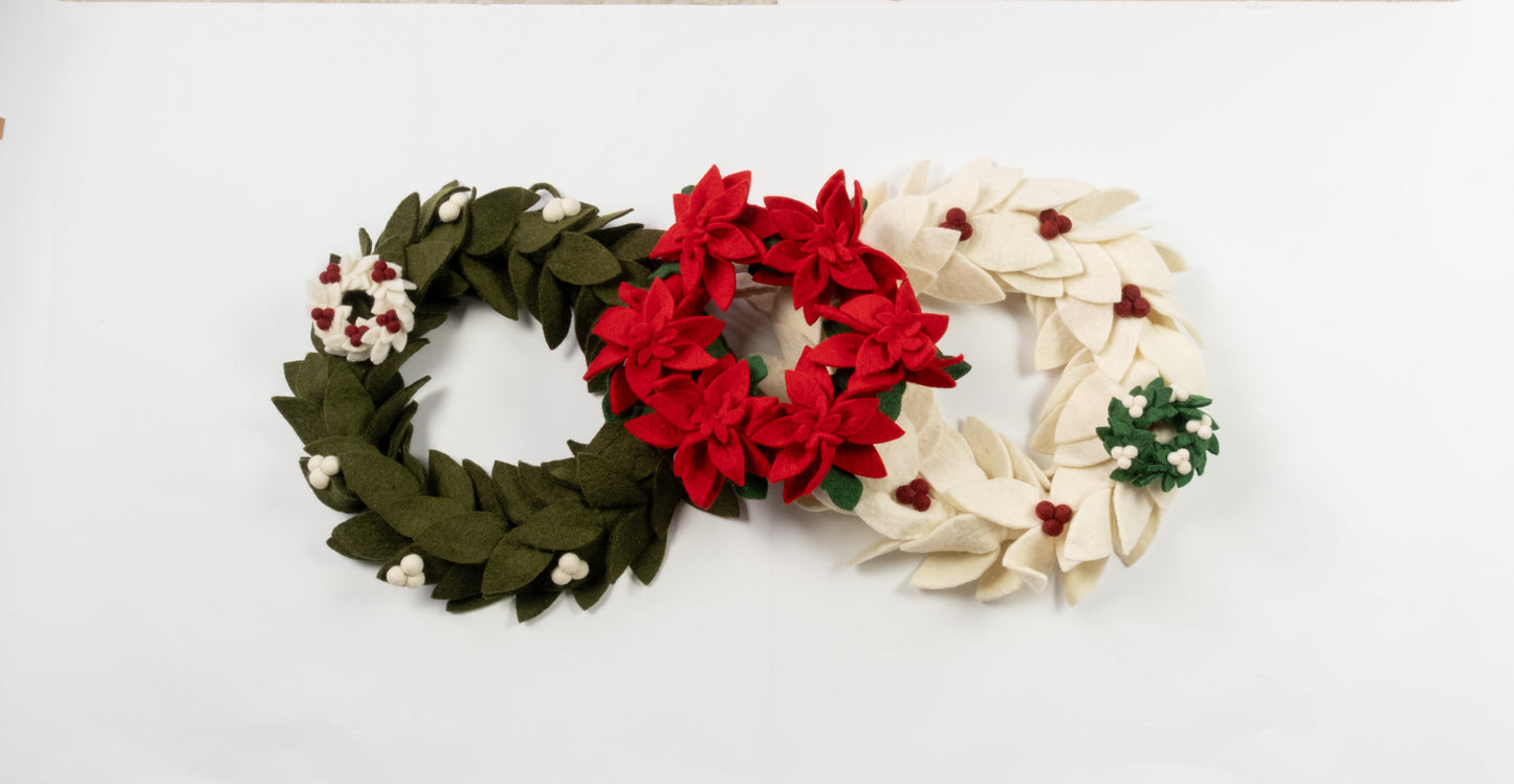 Felt ornaments of mini wreaths in green, red, and white.