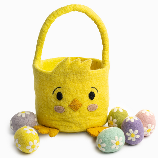 Felt easter basket of a yellow chick with felt easter eggs scattered around.
