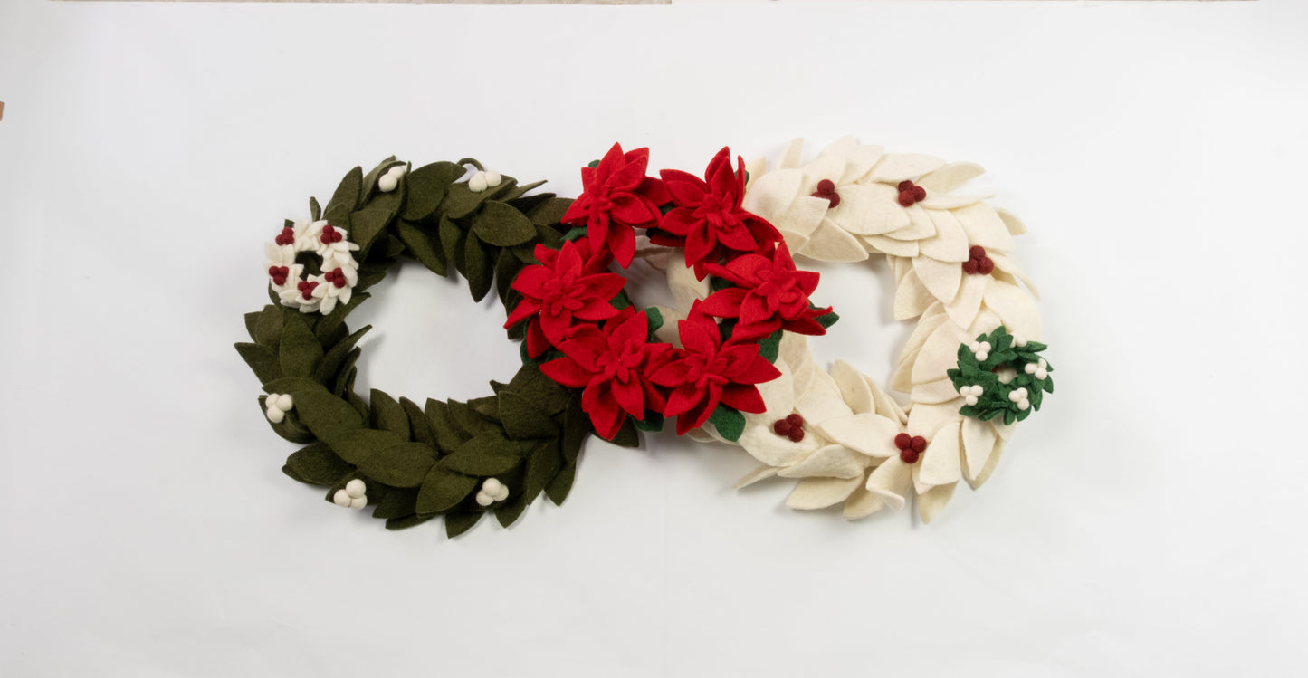 Felt ornaments of mini wreaths in green, red, and white.