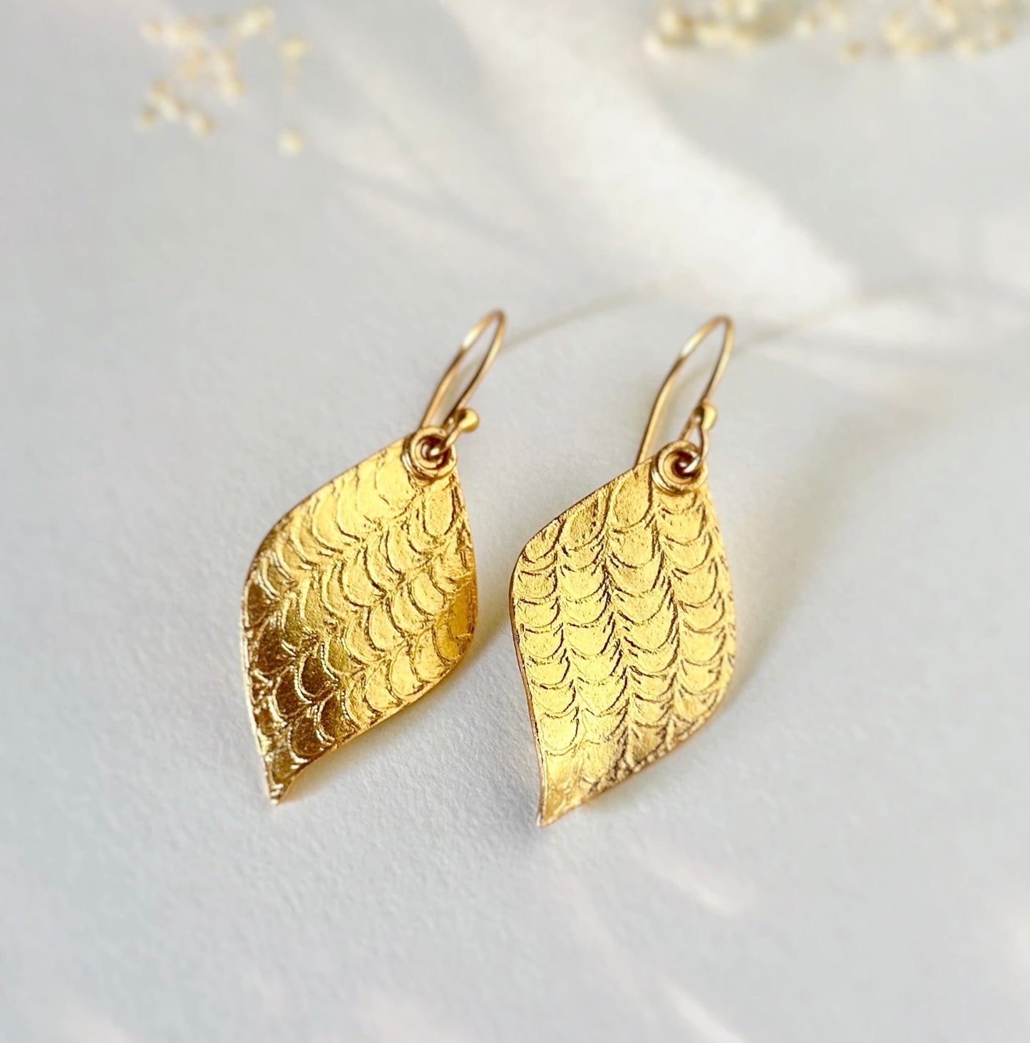 Pair of gold leaf earrings.