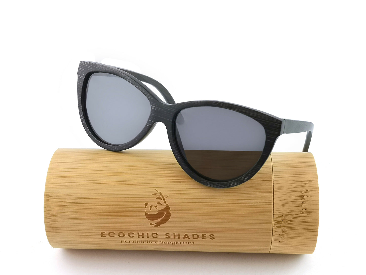 Black bamboo sunglasses with black frames on cylindrical bamboo case.