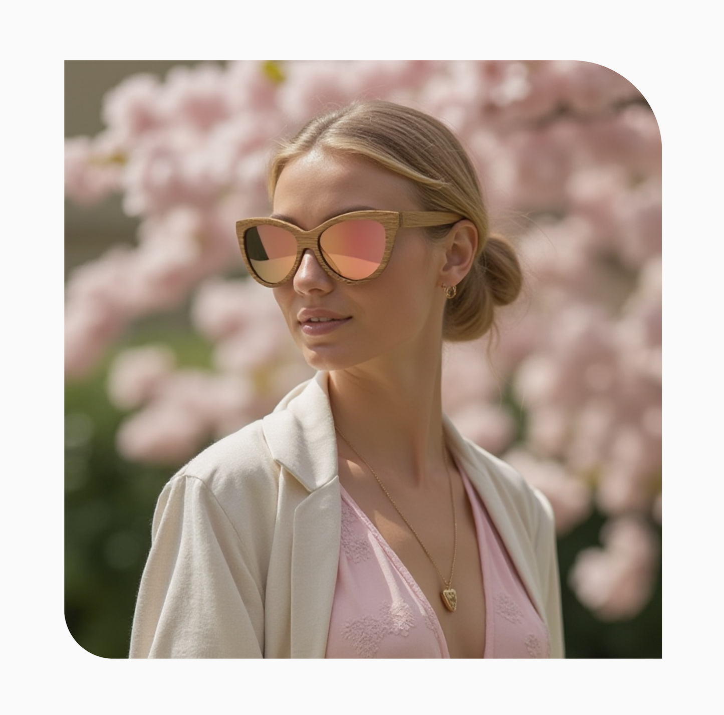 Blond woman with hair in bun wearing natural colored bamboo sunglasses with rose gold mirrored lenses.