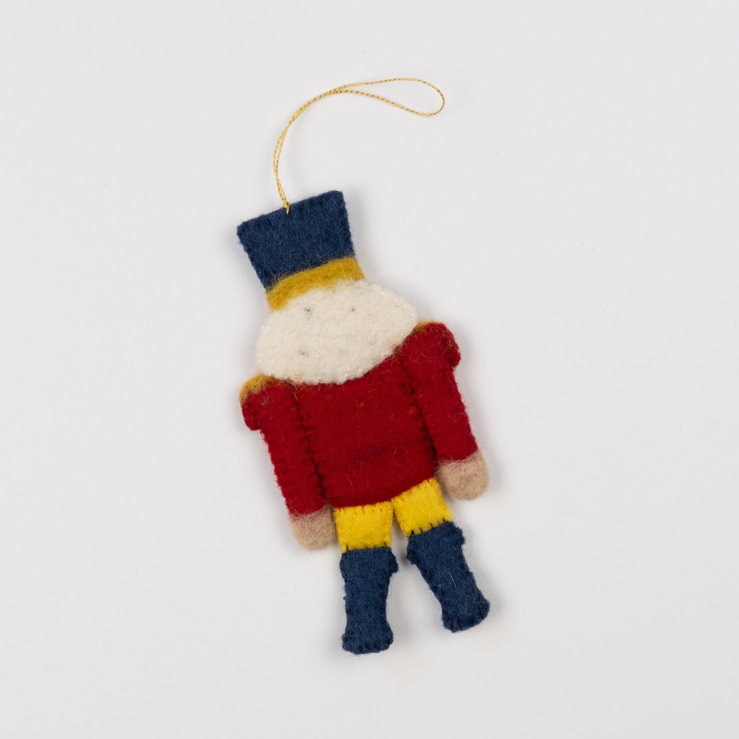 Back view of a felt ornament of a red and gold nutcracker.