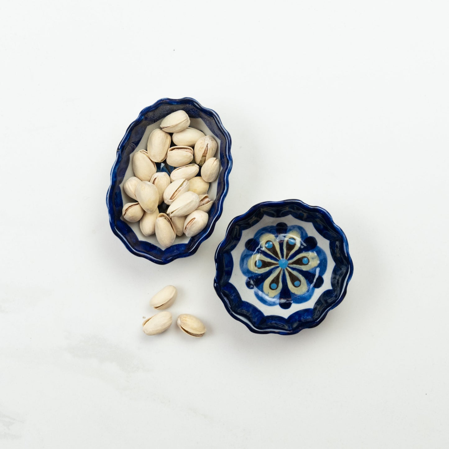 Blue and white painted round and oval tapas bowls.