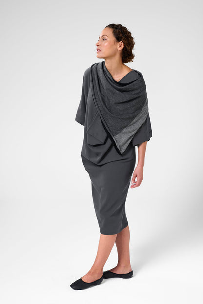 Front left view of woman wearing scarf in black, charcoal, and light grey.