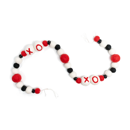Felt garland with XO and red, white and black balls in between.