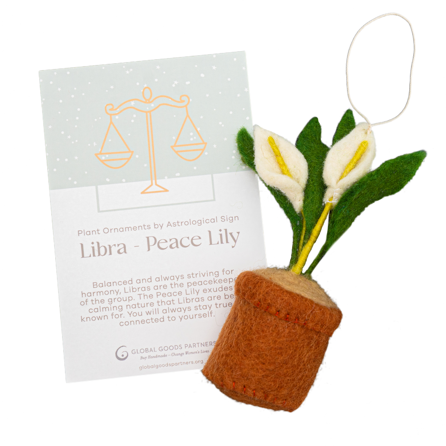 Felt ornament of a Peace Lily plant with white flowers in a brown pot with a Libra astrology card.