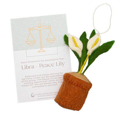 Felt ornament of a Peace Lily plant with white flowers in a brown pot with a Libra astrology card.