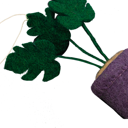 Felt ornament of a Monstera plant in a purple pot.