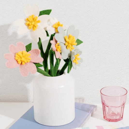 Pink, white, and light grey felt Dogwood flowers in white vase.